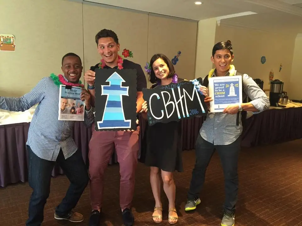 Staff holding CBHM lighthouse signs
