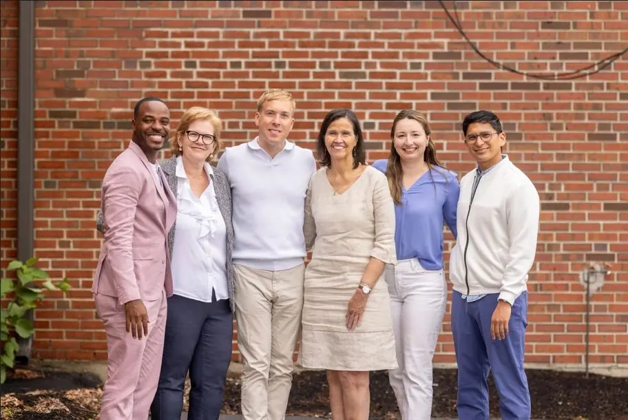 Project PROVIDE mentors and interns in front of a brick wall