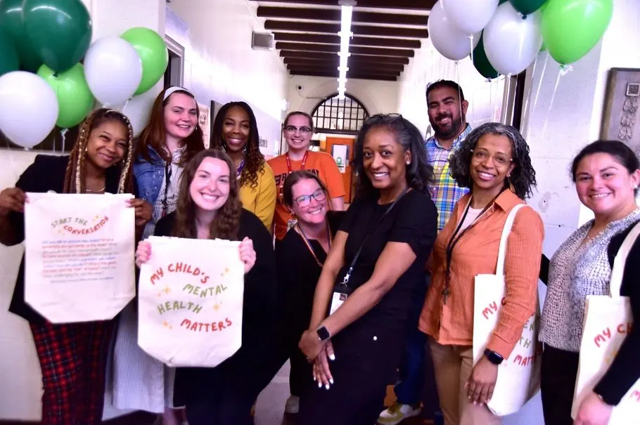 Project PROVIDE interns and mentors celebrating together with balloons and tote bags reading My Child's Mental Health Matters