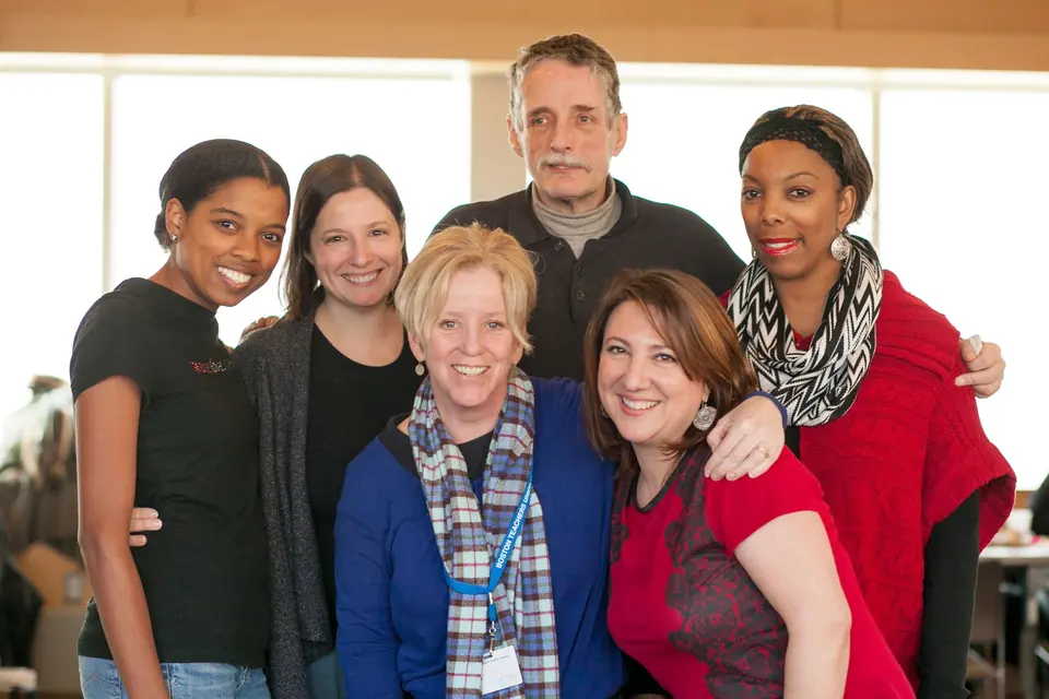 A group of school psychologists gathered around a table at a celebration